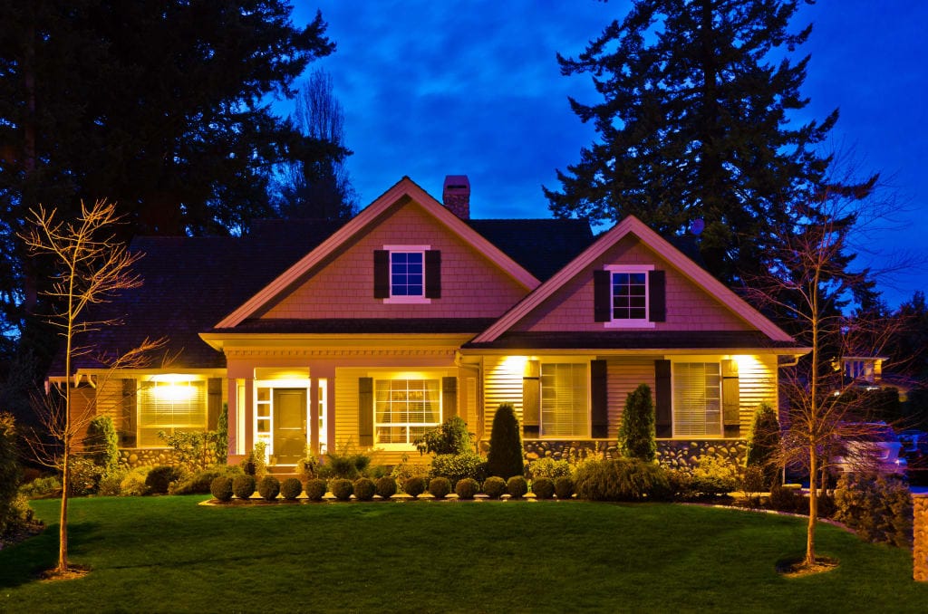 Front of a house with layered landscape lighting